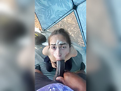 A cute Latin bitch publicly sucks a big black dick right in the tent.