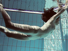 Gorgeous Sima swims naked in a pool exposing her beauty