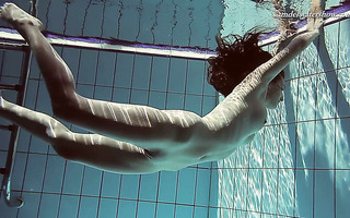 Gorgeous Sima swims naked in a pool exposing her beauty